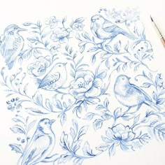 a drawing of blue birds and flowers on white paper