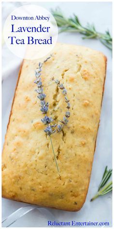 a loaf of lemon lavender tea bread on a white plate with rosemary sprigs