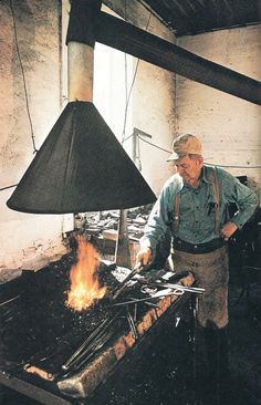 an old man standing in front of a stove with a flame coming out of it