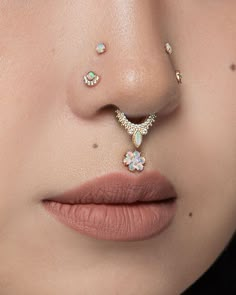 a woman's nose with piercings on it