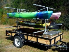 a trailer with two kayaks attached to it