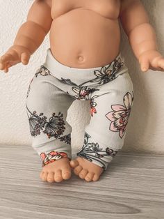 a baby doll is standing on the floor