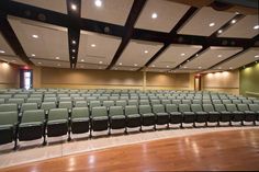 an empty auditorium with rows of seats in it