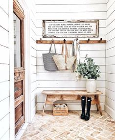 a wooden bench sitting next to a wall with two purses hanging on it's hooks