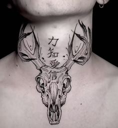 a man with a tattoo on his neck has a deer's skull and chinese characters