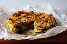 a quiche with cheese and spinach on top is cut in half to show it's filling