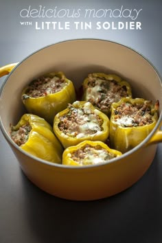 stuffed bell peppers in a yellow pot with the title delicious monday written above it on top