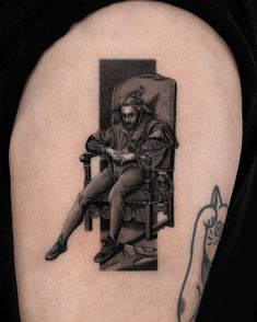 a black and white photo of a man sitting in a chair