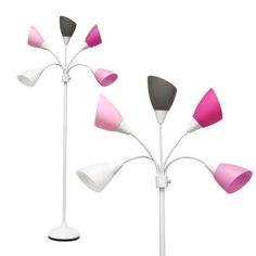 three pink and black lamps on a white stand