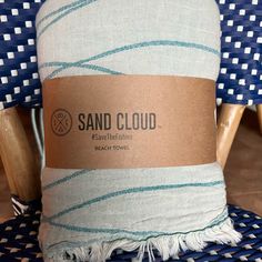 a blue and white towel sitting on top of a wooden chair