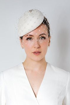 Olive is a beautiful wedding birdcage veil hat with a modern style oversize veil and fine diamanté detailing. This hat is made to order from high-quality velour felt, hand-made by me in my studio in Scotland.  This elegant bride's hat would work well with a structured dress or wedding suit but is equally suitable for a vintage-style wedding. The hat can be finished with different detailing (shown in the images and video), however, this is a bespoke request, so please get in touch in the first in Veil Hat, Olive Wedding, Wedding Birdcage, Veiled Hats, Style Oversize, Bride Hat, Bridal Hat, Wedding Hat, Birdcage Veil