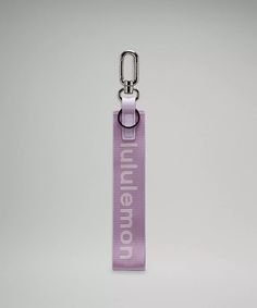 a purple lanyard with the words millennium on it and a metal keychain