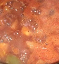 a pot filled with stew sitting on top of a stove