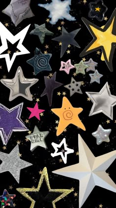 many different colored stars on a black background