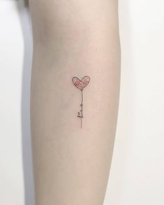 a small heart shaped balloon with the word love written on it's side tattoo