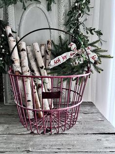 a pink basket filled with lots of logs