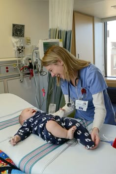 a female doctor examining a baby's heartbeat