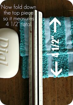 a close up of a towel on a table with a measuring tape and soap dispenser