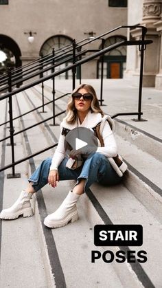 a woman sitting on the steps with her legs crossed and looking at something in front of her