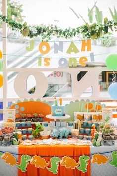 an orange and green dinosaur themed birthday party