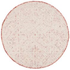 a round rug with red and white designs on it