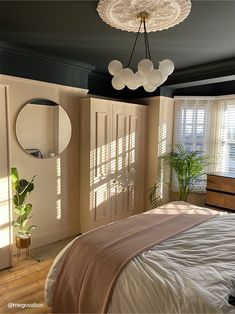 a bed sitting in a bedroom next to a window