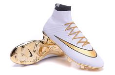 a pair of white and gold soccer cleats