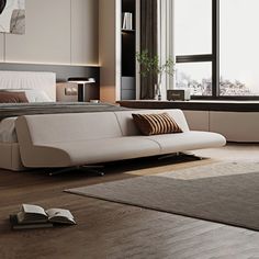 a bedroom with a bed, couch and book on the floor in front of a window