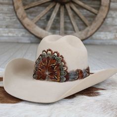 The Rowan (short) is a smaller version of our best selling hat band. Specially designed for small sized hats (6 7/8 and under) and kids hats.    100% Feather  Length: approx. 53cm (not including leather ties)  Width: 2cm  Crest dimensions: 4"w X 3.25"h Western Cream Hat With Short Brim, Flat Bill Hats For Kentucky Derby, Adjustable Brown Mini Hat With Short Brim, Brown Adjustable Mini Hat With Short Brim, Adjustable Brown Mini Hat With Flat Brim, Kentucky Derby Flat Bill Hat, White Western Hat With Flat Bill, Adjustable Cream Hat For Western-themed Events, Adjustable Fit Brown Hat For Country Events