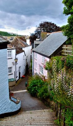 an aerial view of some houses and steps leading up to the roof tops in this small town