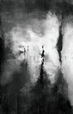 black and white photograph of people walking on the beach in front of an overcast sky