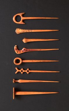 an assortment of wooden utensils on a black surface