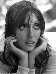 a black and white photo of a woman with freckles on her eyes looking at the camera