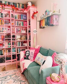 a living room filled with lots of pink and green furniture next to a book shelf