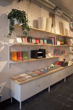 the shelves are filled with books and other items in this office space that is well organized