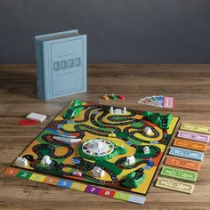 a board game sits on a table next to its contents and instructions for the game