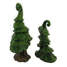 two green glass christmas trees sitting next to each other