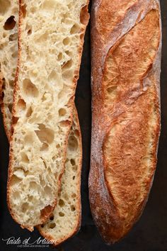 two loaves of bread sitting next to each other on top of a black surface