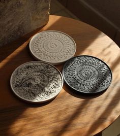 three plates sitting on top of a wooden table