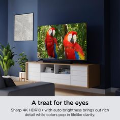 a flat screen tv sitting on top of a wooden entertainment center in a living room