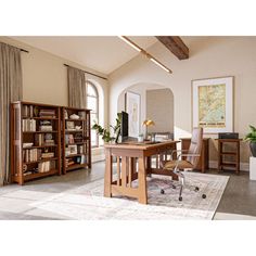 an office with a desk, chair and bookcases in it's center