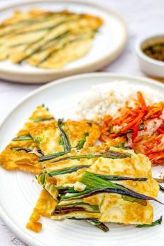 an omelet with vegetables and rice on a plate next to other food items