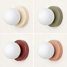 four different colored knobs on the side of a white wall and one has an egg in it