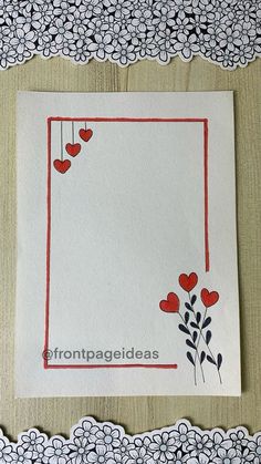 a piece of paper with hearts hanging from it's sides on a doily