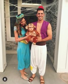 a man and woman dressed up as disney characters