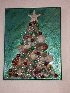 a christmas tree made out of seashells and starfish