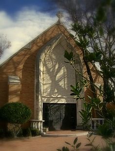 an old church with trees in front of it