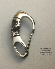 a pair of scissors shaped like a skull on a white background with the words trickskills written below it