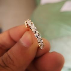 a close up of a person holding a ring with diamonds on the inside of it