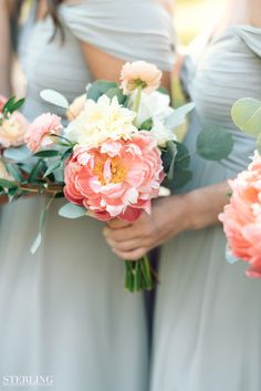 the bridesmaids are holding their bouquets together